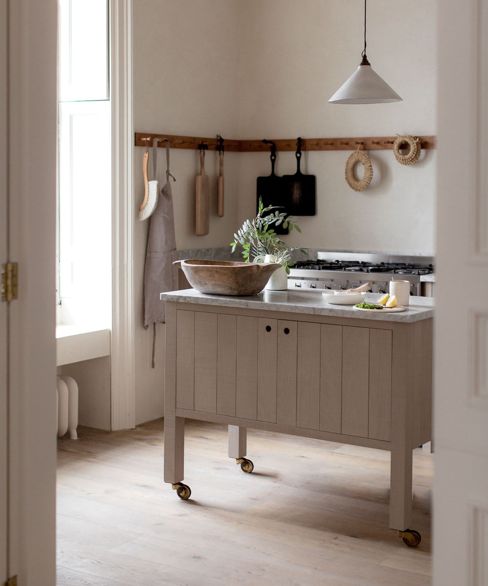Pink kitchen with a butchers block for an island