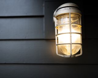 Illuminated outdoor porch light sconce with nautical style