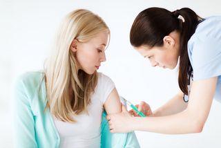 A woman gets a vaccination