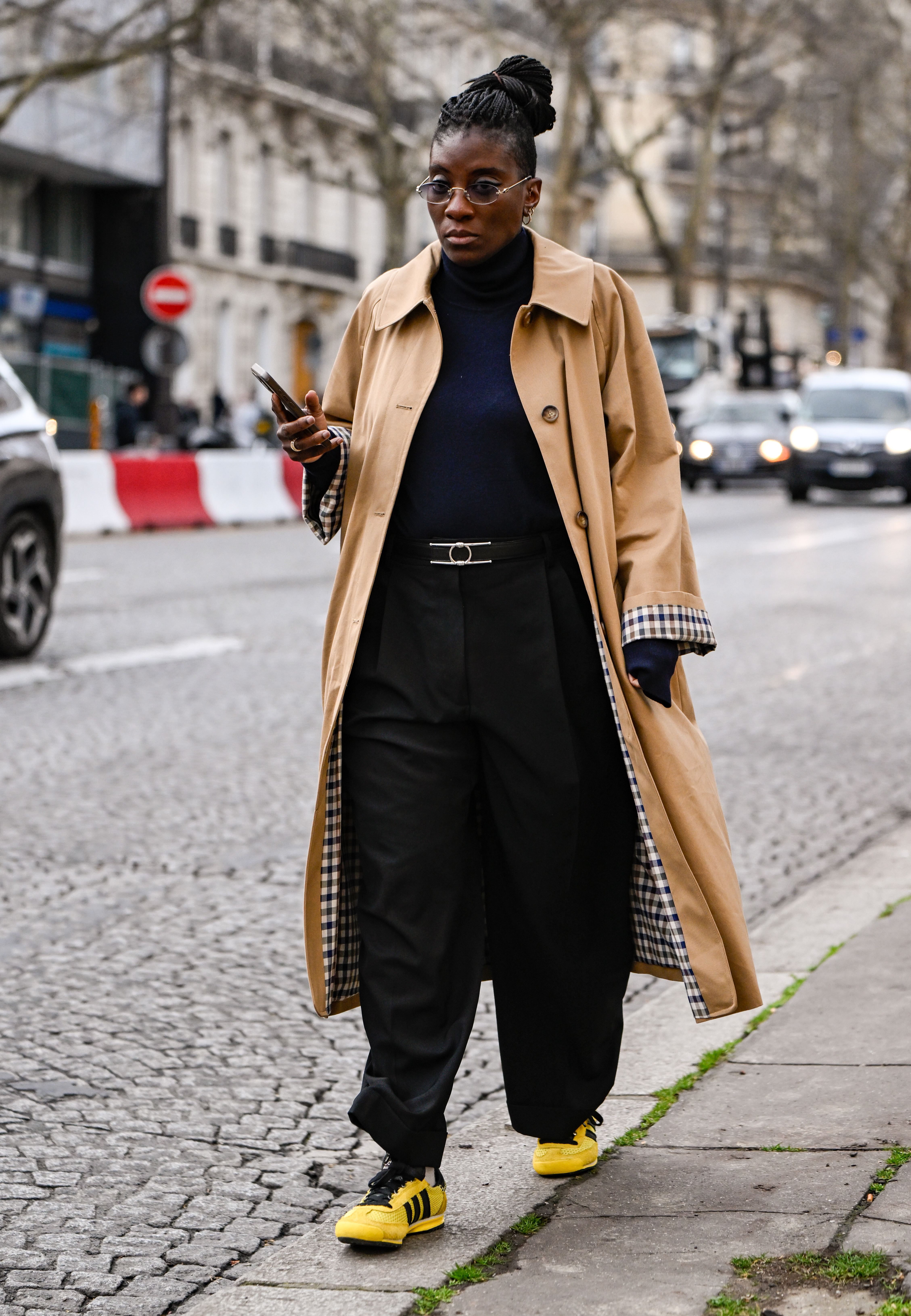 PARIS, FRANCE - MARCH 10: Nikki Ogunnaike is seen wearing a tan and plaid coat, black top, black pants and yellow and black sneakers outside the Rokh show during the Womenswear Fall/Winter 2025/2026 as part of Paris Fashion Week on March 10, 2025 in Paris, France. (Photo by Daniel Zuchnik/Getty Images)