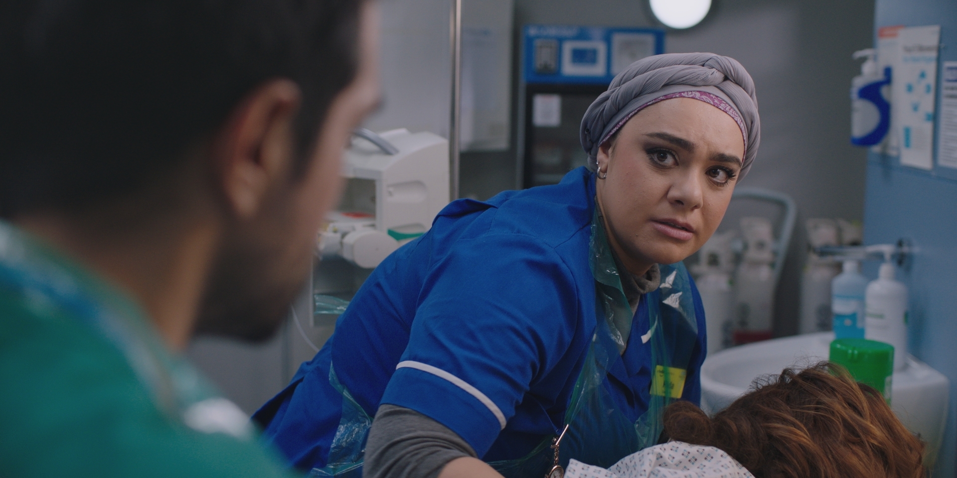 Rida looks at Rash worried that their patient is going to die after Sunny's mistake