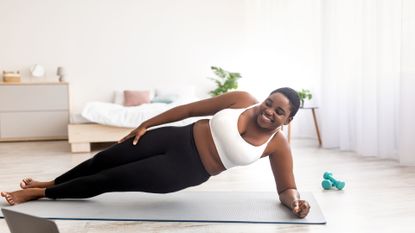 woman doing plank in living room