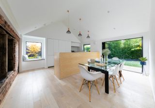 open plan kitchen in a vaulted space with a large patio door