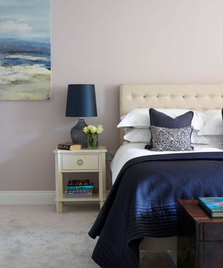 bedroom with navy coloured lamp and navy couch on bed