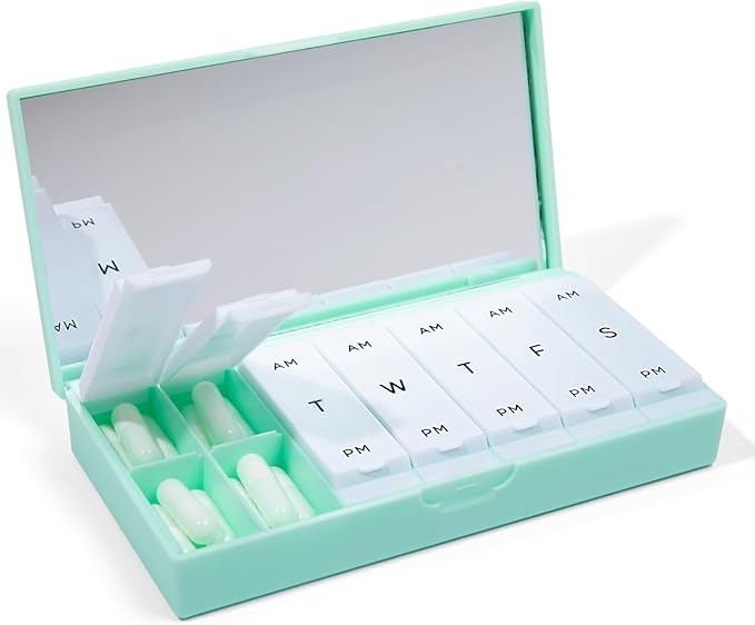 A mint green Port and Polish travel pill organizer