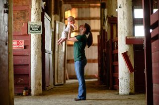 Moore, here with her six-month-old son Jacob, boards horses on-base and rides in her off-duty time.