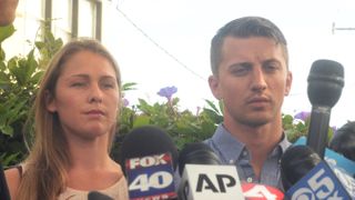 Denise Huskins and Aaron Quinn stand in silence during a press conference on July 13, 2015
