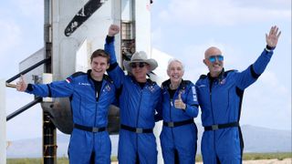 Blue Origin's first New Shepard crew (L-R) Oliver Daemen, Jeff Bezos, Wally Funk, and Mark Bezos pose for a picture near the booster after flying into space in the Blue Origin New Shepard rocket on July 20, 2021 in Van Horn, Texas.