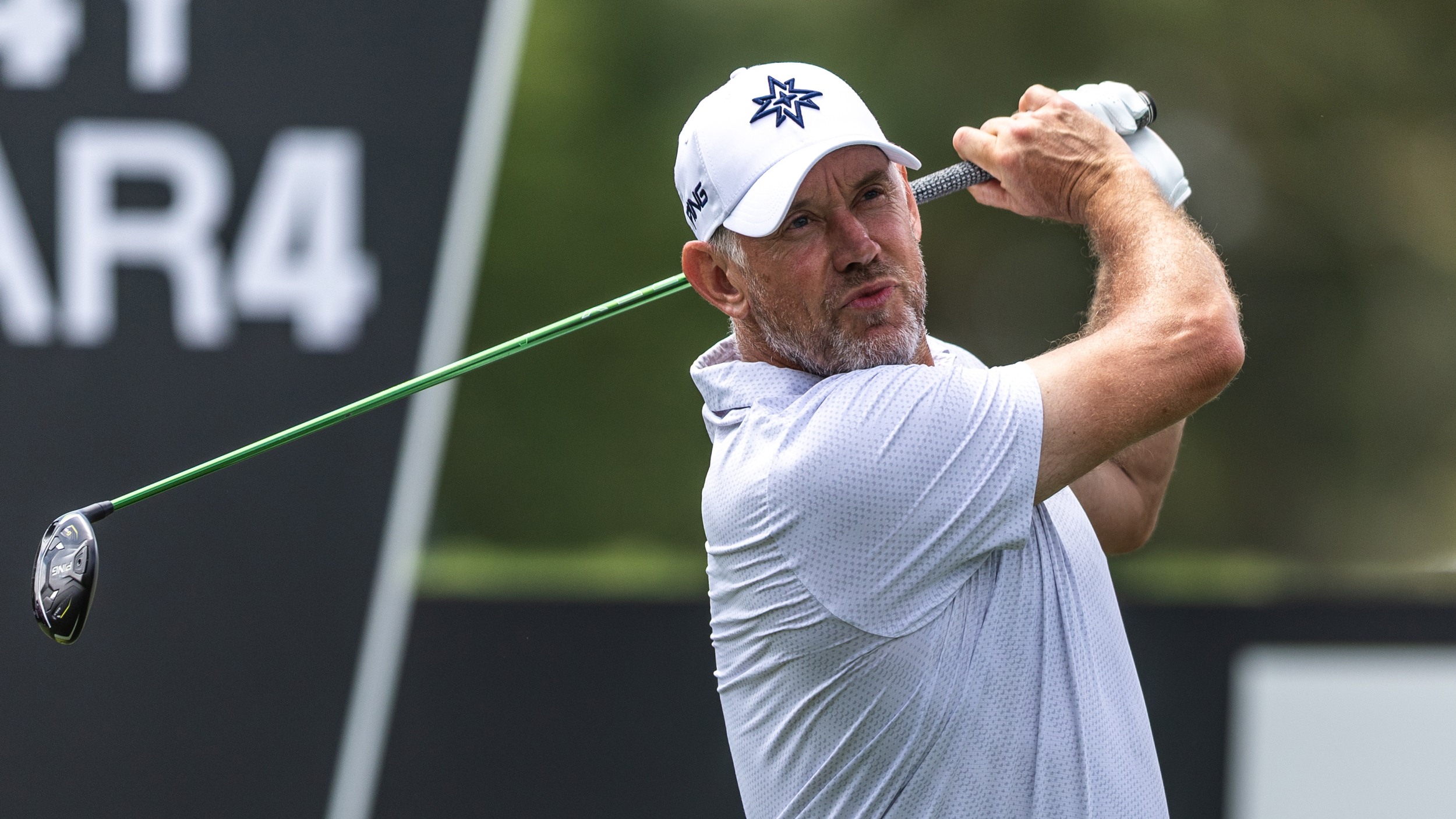 Lee Westwood plays a fairway wood shot