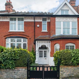 Red brick house exterior with white door