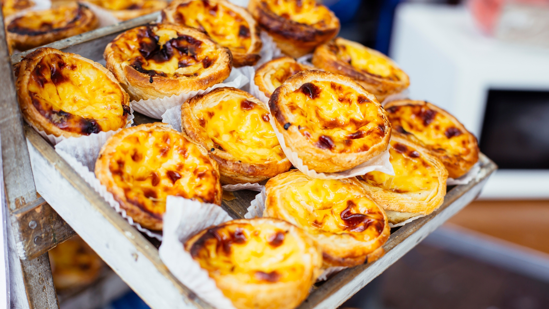 A tray of fresh pastal de nato's emerges from the oven