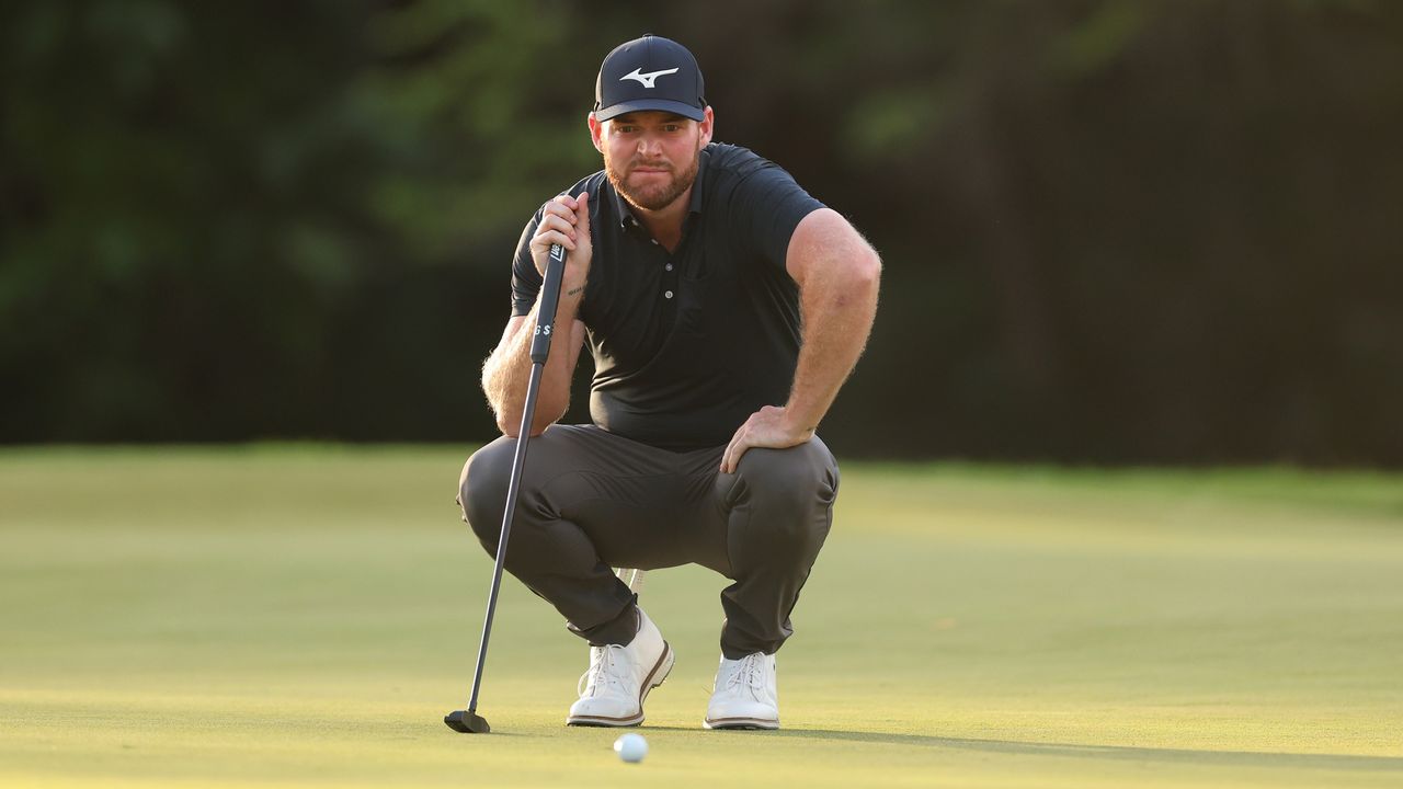 Grayson Murray crouches down before a putt at the 2024 Sony Open