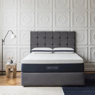 The Brook + Wilde Ultima mattress on an upholstered bed in a bedroom with decorative panelling