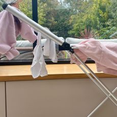 beldray winged heated clothes airer with hanging clothes close up