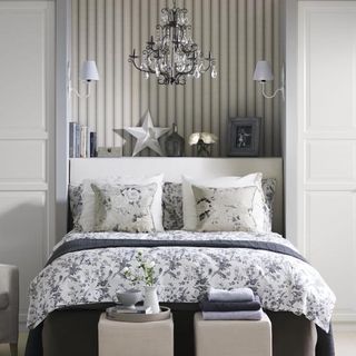 bedroom with sliding wardrobe doors and chandelier