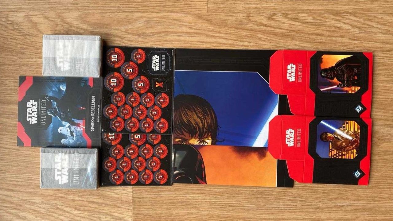 Star Wars Unlimited contents on a table, it includes two decks, counters and paper playmats