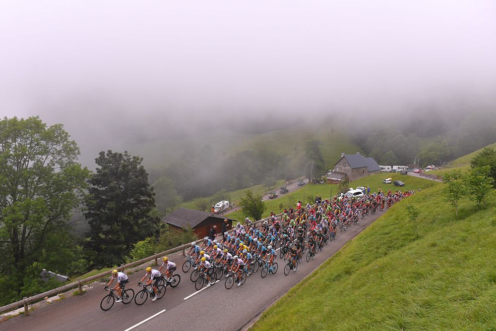 The peloton climbs into the fog during stage 12 at the Tour de France