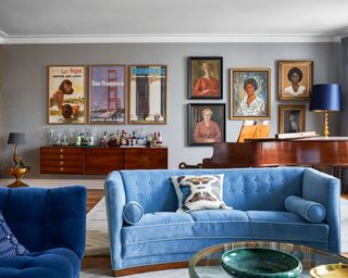 neutral living room with blue velvet sofa and grey walls