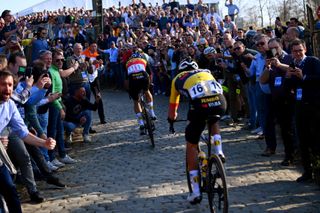 HARELBEKE BELGIUM MARCH 25 LR Wout Van Aert of Belgium and Christophe Laporte of France and Team Jumbo Visma compete in the breakaway through Kwaremont cobblestones sector while fans cheer during the 65th E3 Saxo Bank Classic 2022 a 2039km one day race from Harelbeke to Harelbeke E3SaxobankClassic WorldTour on March 25 2022 in Harelbeke Belgium Photo by Tim de WaeleGetty Images