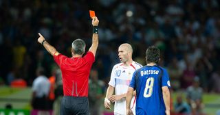 Horacio Elizondo of Argentina the referee issues the red card to Zinedine Zidane of France after the headbutt on Marco Materazzie of Italy (not pictured), Gennaro Gattuso of Italy watches on during the World Cup Final match between France (1) and Italy (1). Italy would win on penalties (5) to (3) at the Olympiastadion on July 09, 2006 in Berlin, Germany.