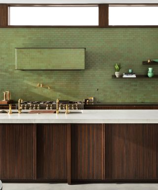 green and brown kitchen with marble countertops, green tiles, brass hardware, wooden