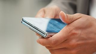 The Huawei Pura X Max being held in the hand