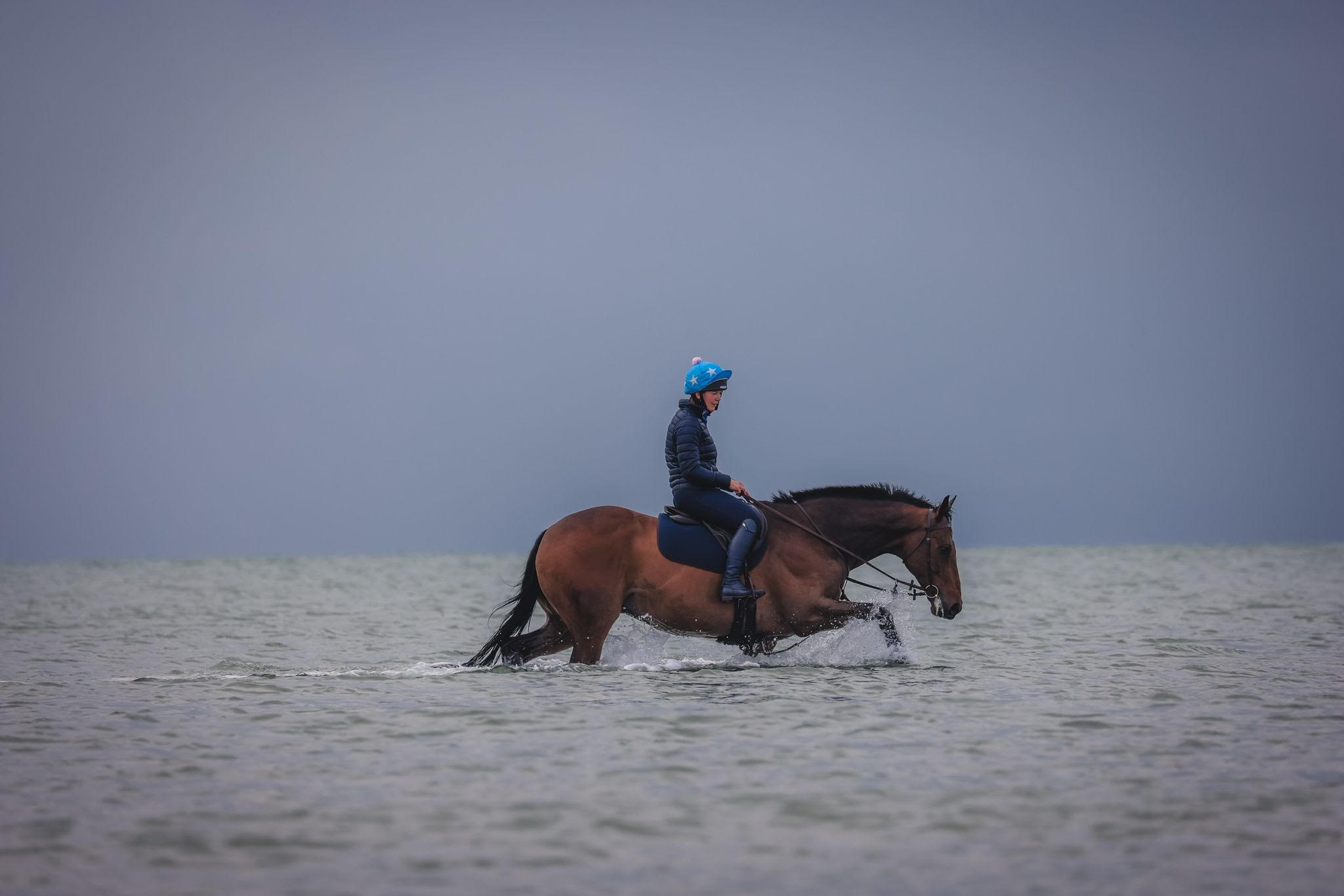 Hannah Bishop and retrained racehorse Annacotty enjoying the beach