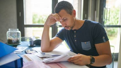man looking at bills