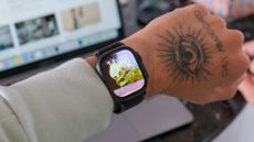 Black Apple Watch Ultra 2 displaying watchOS 26