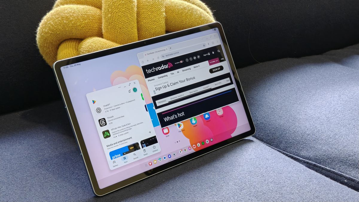 The Samsung Galaxy Tab S10 FE Plus leaning on a yellow cushion
