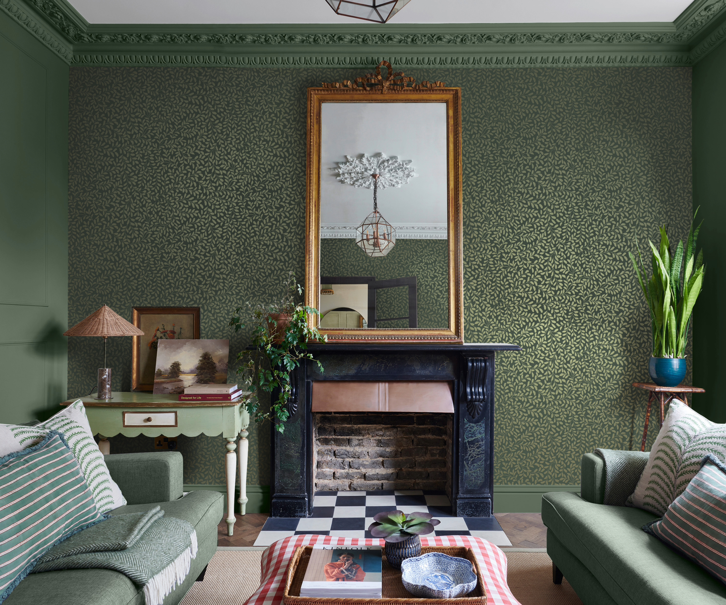 Green living room with wallpaper feature wall and gold mirror