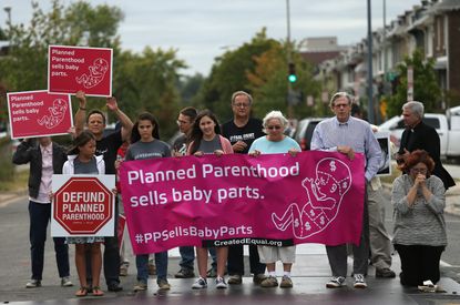 Protesters as Republicans to defund Planned Parenthood.