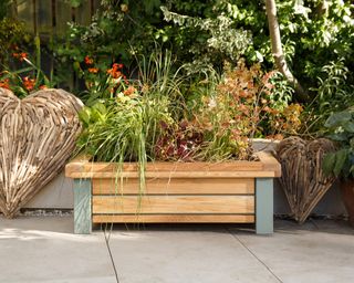 Sturdy wooden planter trough with gray legs