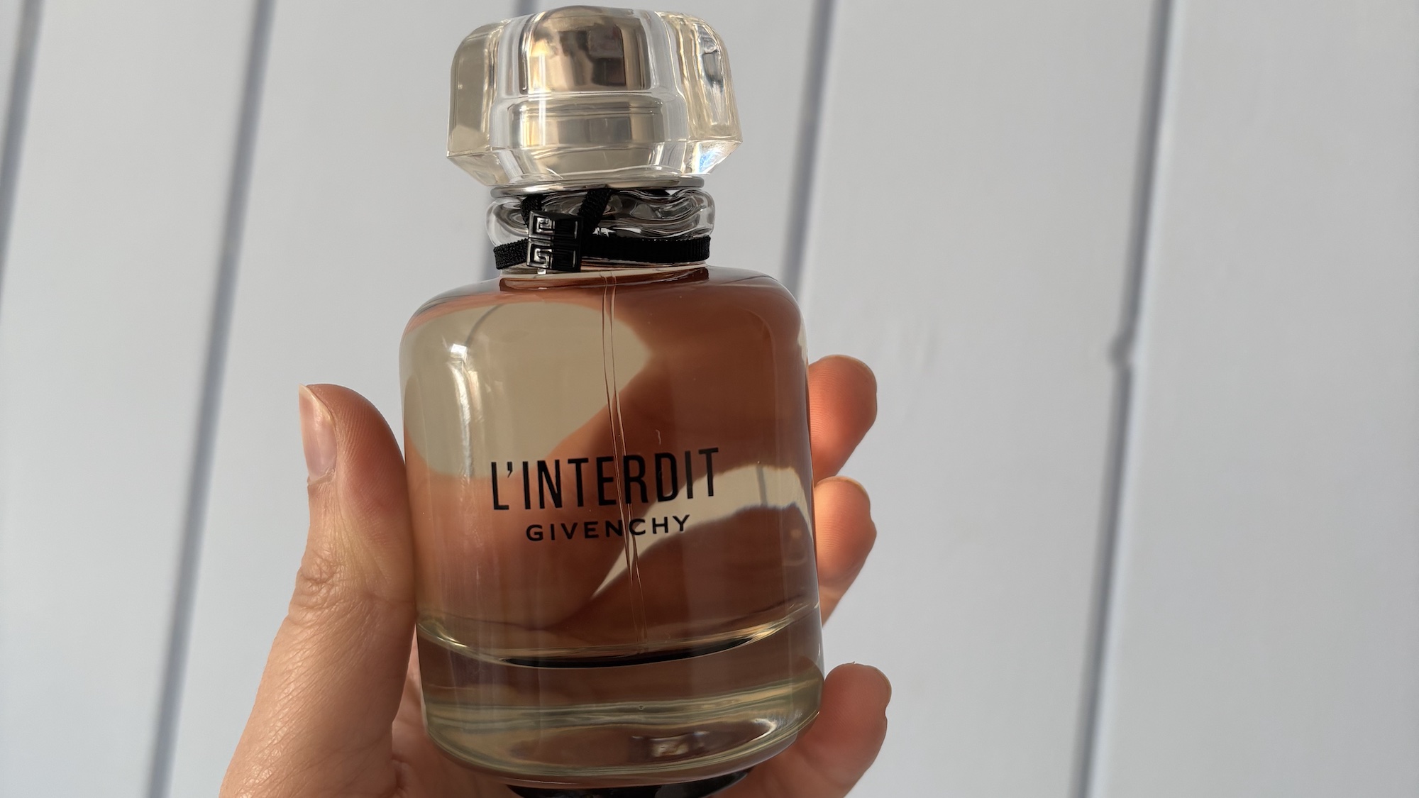 Mica Ricketts holding Givency L'Interdit EDP