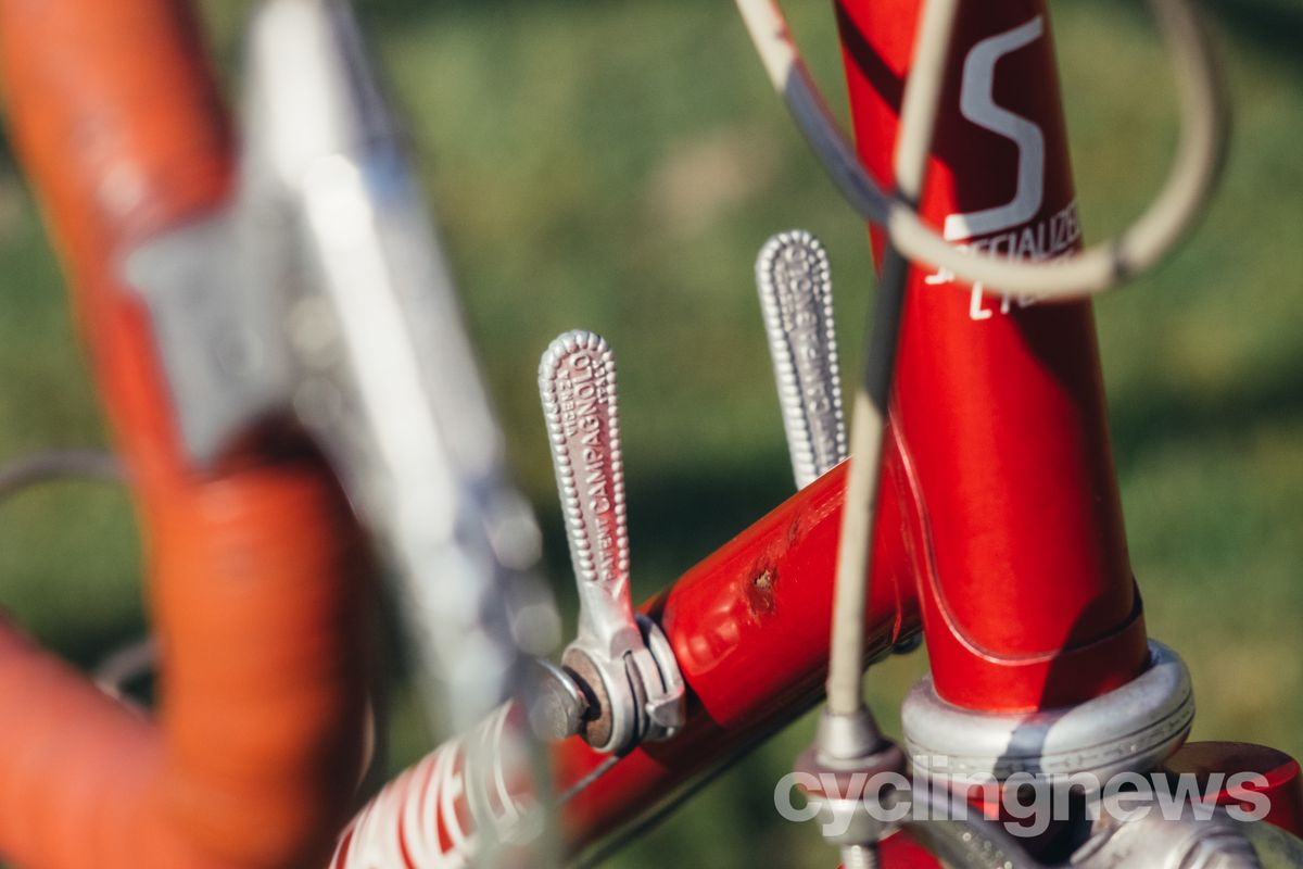 close up of campagnolo downtube shifters on a red bike
