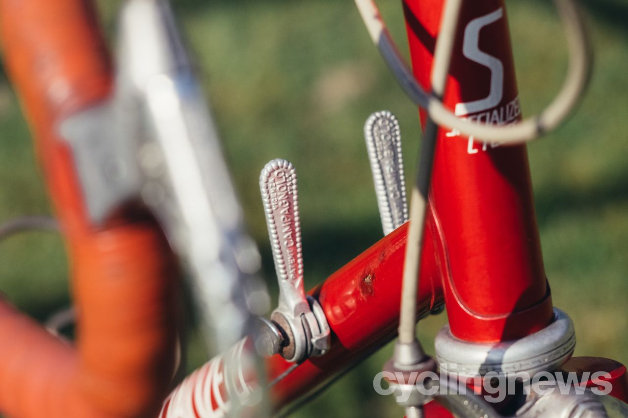 close up of campagnolo downtube shifters on a red bike