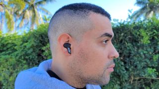 Our reviewer wearing the Adidas Z.N.E. 01 ANC wireless earbuds