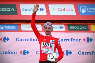 OEIRAS PORTUGAL AUGUST 17 Brandon McNulty of The United State and UAE Team Emirates celebrates at podium as Red Leader Jersey winner during the 79th La Vuelta Ciclista a Espana 2024 Stage 1 a 12km individual time trial stage from Lisbon to Oeiras UCIWT on August 17 2024 in Oeiras Portugal Photo by Tim de WaeleGetty Images