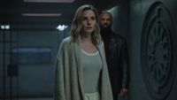 a woman and a man in a dark corridor