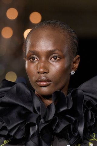 model at Richard Quinn S25 show wearing glowy skin makeup