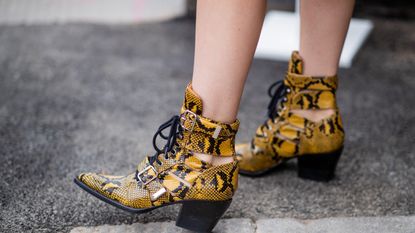 woman wearing yellow snakeskin summer boots