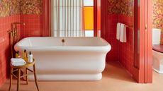 a bath in an orange bathroom