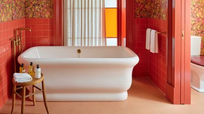 a bath in an orange bathroom