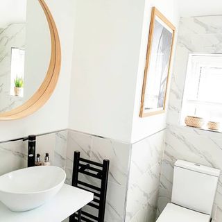 bathroom white wall with tiles and two mirrors on wall and sink
