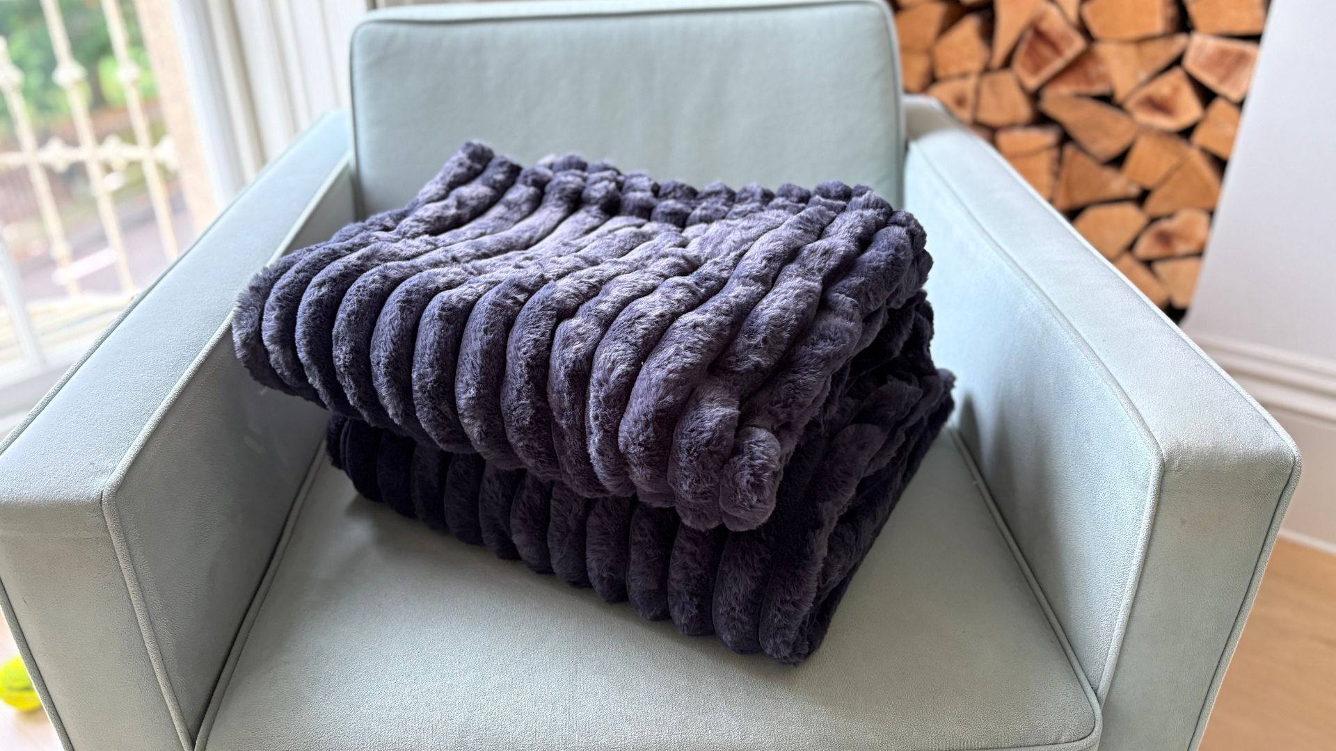 The Morphy Richards EverCosy Heated Throw on a chair, being tested for our review