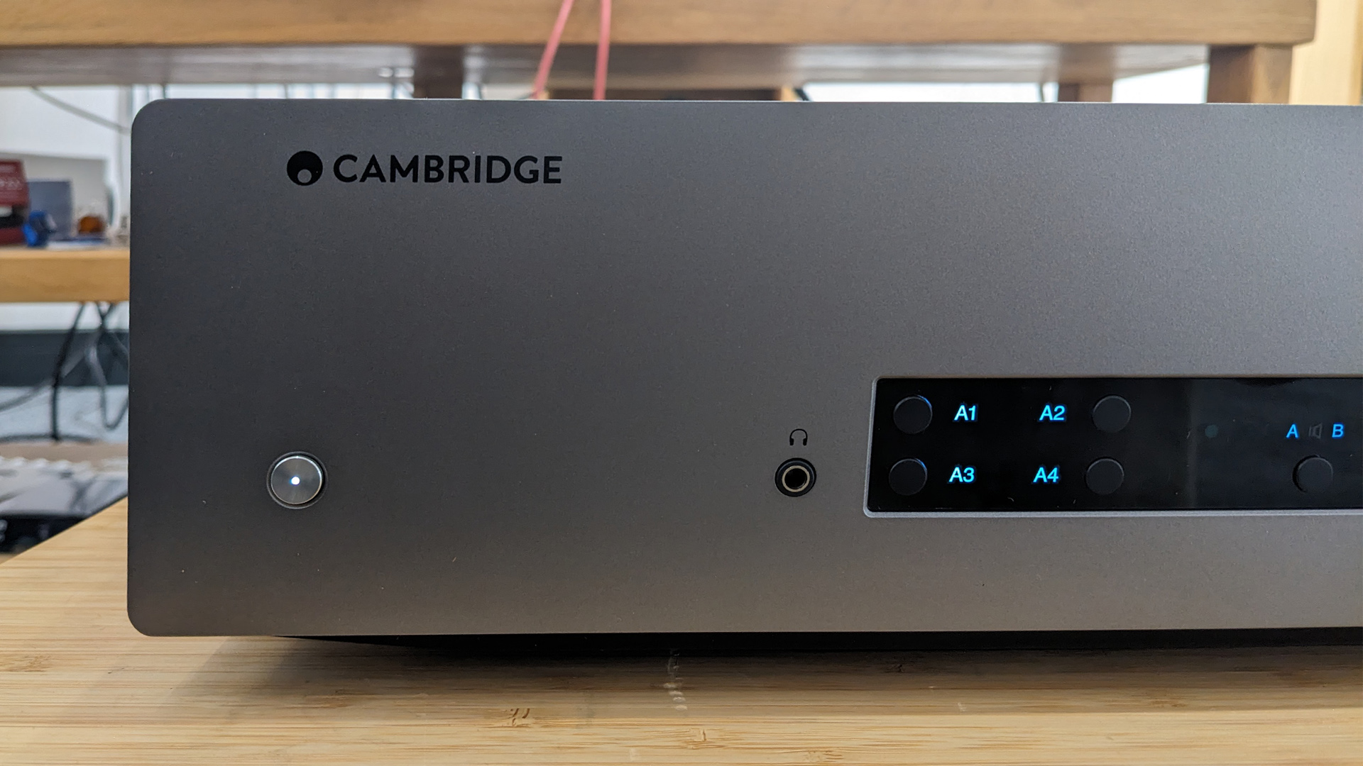 Cambridge Audio CXA81 MKII integrated amplifier close up on left side of front panel showing power button and display