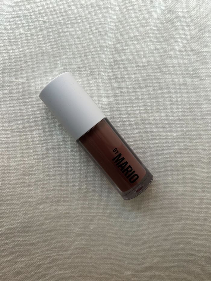 The Makeup By Mario SuperShine&amp;trade; Lip Gloss on a white linen background