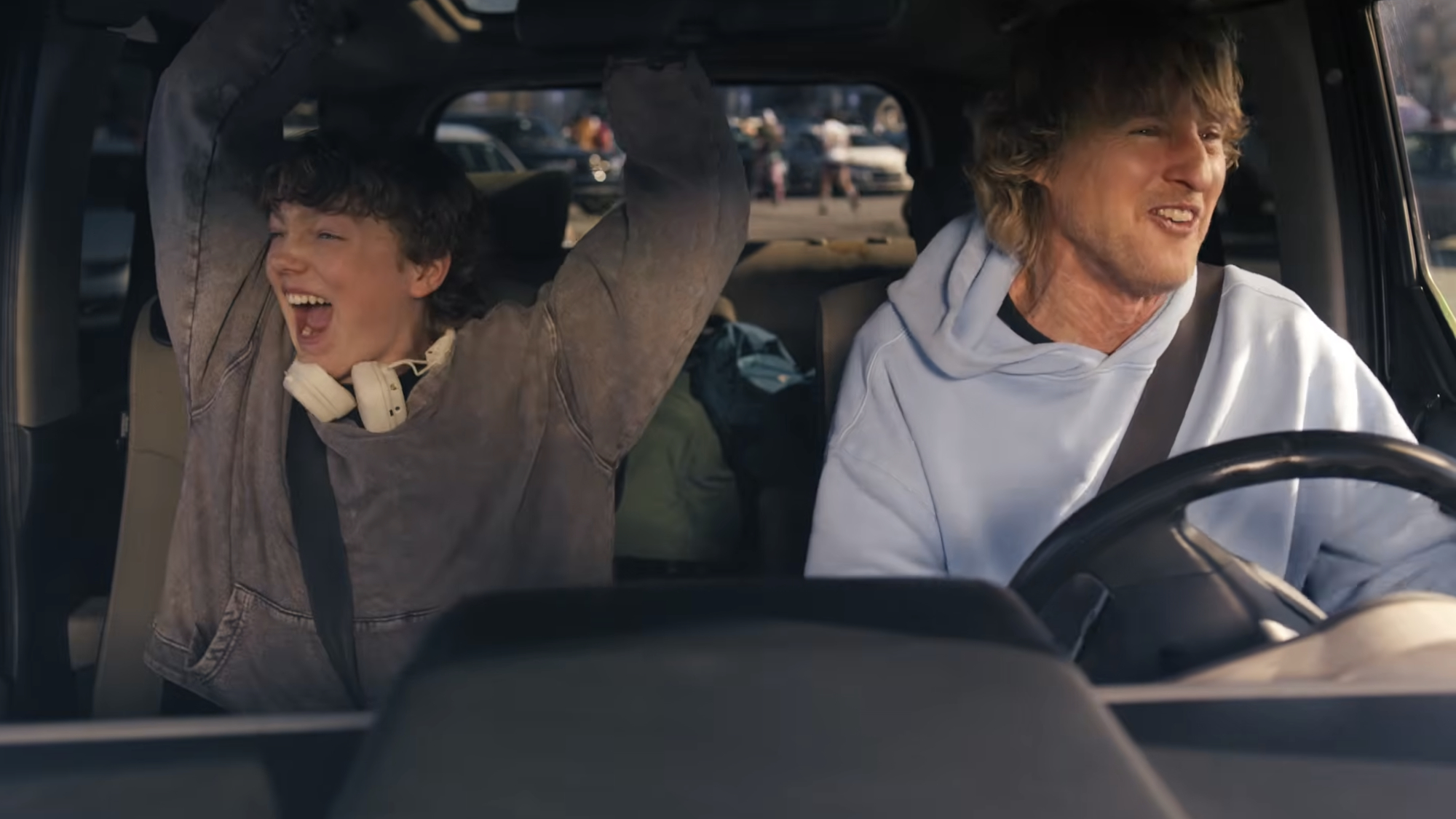Owen Wilson and Christian Convery's characters cheer as they head to a music festival in Rolling Loud: The Movie.