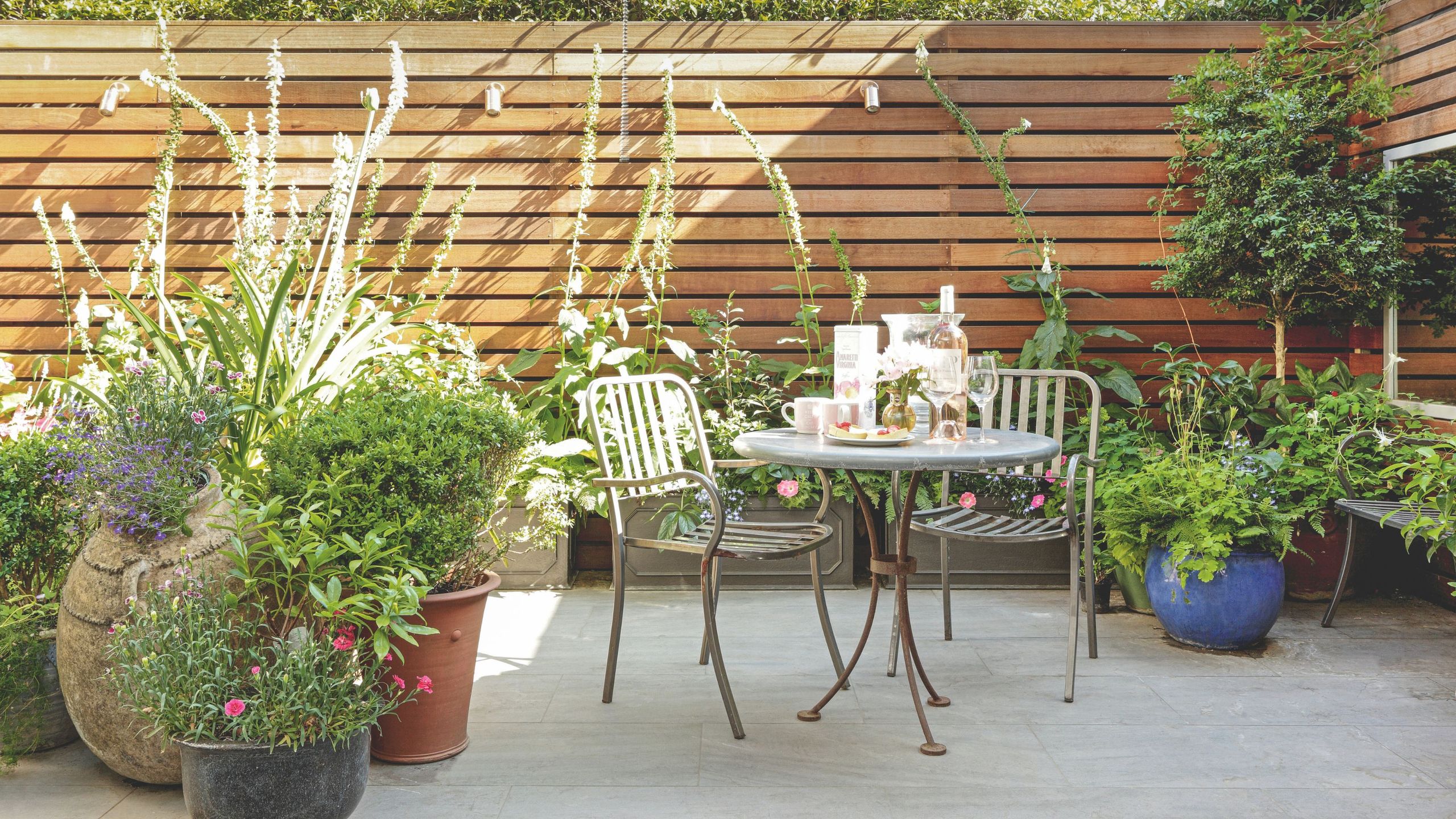 IKEA's pretty plant shelf has transformed my small concrete garden – it's doubled the amount of blooms I can grow in the tiny outdoor space