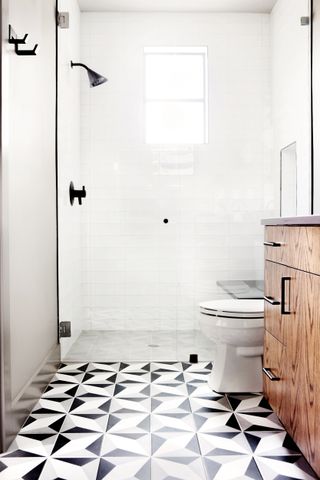 modern shower room with white subway tiles and monochrome flooring